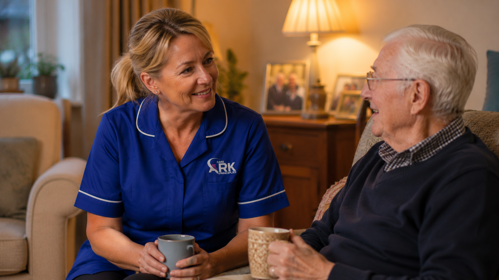 Ark Care Principles male carer in blue uniform in a bright home setting